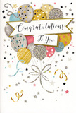 The photograph features a celebratory congratulations card whose design feels like a quiet burst of joy, similar to the atmosphere after good news is shared in a cosy West Green café. A bouquet of illustrated balloons rises from the lower part of the card front, the shapes softly rounded and slightly translucent in appearance, layered to create a gentle three-dimensional effect. Their colours are soothing yet festive: warm gold, pale champagne, polished silver, cool blue, rose pink, and misty grey. Many of the balloons are decorated with tiny stars, subtle stripes, and fine glittering details, suggesting a lightly textured surface that would catch the light if you tilted the card in your hands. Fine, curling ribbons trail from the balloon cluster, drawn in flowing metallic lines that twist and cross like celebratory streamers strung above a family gathering near West Green Road. Around the balloons, small stars, dots of confetti, and looping flourishes drift across a light, neutral background, giving the impression of movement and sparkling air. At the heart of the design, an elegant banner stretches across, its edges gently curled as though made from soft fabric. The phrase Congratulations To You appears in refined calligraphy on this banner, the letters sweeping gracefully from one to the next and lending the card a touch of timeless sophistication. The overall mood is one of heartfelt pride and happiness-a versatile, stylish card that would sit beautifully beside a vase of fresh blooms, marking graduations, promotions, or any cherished milestone for someone special in the local community.